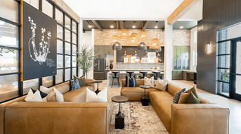 A modern living room with a large sectional sofa and a coffee table.